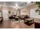 Inviting living room with dark wood floors, stylish decor, and comfortable leather sofas at 14228 W Weldon Ave, Goodyear, AZ 85395