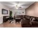 Comfortable living room with a large sectional sofa, TV, and textured wall at 14228 W Weldon Ave, Goodyear, AZ 85395