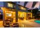 Spacious outdoor patio area with a pool, seating, hot tub, and outdoor kitchen at 14228 W Weldon Ave, Goodyear, AZ 85395