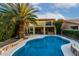 Inviting backyard with large pool, hot tub, patio, balcony, and lush landscaping perfect for outdoor living at 14228 W Weldon Ave, Goodyear, AZ 85395