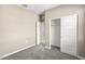 Comfortable carpeted room with neutral walls, closet, and an open door to the hallway at 1423 S 239Th Dr, Buckeye, AZ 85326