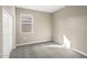 Neutral bedroom features a window with blinds and a closet with sliding doors at 1423 S 239Th Dr, Buckeye, AZ 85326