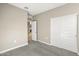 Well-lit room featuring neutral walls and carpet, showcasing an open doorway and closet at 1423 S 239Th Dr, Buckeye, AZ 85326