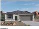 Beautiful elevation rendering with desert landscaping, showcasing the home's architecture at 1423 S 239Th Dr, Buckeye, AZ 85326