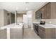 Contemporary kitchen with stainless steel appliances, an island, and ample cabinet space at 1423 S 239Th Dr, Buckeye, AZ 85326