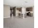 Spacious living room with open layout, highlighting the kitchen island and tile floors at 1423 S 239Th Dr, Buckeye, AZ 85326