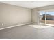 Bright living room with tile flooring and a sliding glass door to the backyard at 1423 S 239Th Dr, Buckeye, AZ 85326