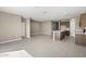 Open concept living space featuring a kitchen with an island and tile flooring at 1423 S 239Th Dr, Buckeye, AZ 85326