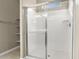 Walk-in shower with glass doors, modern fixtures, and built-in shelving at 1423 S 239Th Dr, Buckeye, AZ 85326