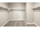 Spacious walk-in closet with carpet flooring and white shelving for ample storage at 1423 S 239Th Dr, Buckeye, AZ 85326