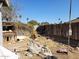 Overgrown backyard needing cleanup, featuring a dilapidated structure, providing an opportunity for landscaping and renovation at 14627 N 33Rd Ave, Phoenix, AZ 85053