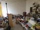 Bright living room with brick accent wall is cluttered and full of items, making it difficult to envision its potential at 14627 N 33Rd Ave, Phoenix, AZ 85053