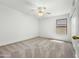 Bright bedroom features neutral carpet, ceiling fan, and a sun-filled window at 17210 N Cassi Dr, Surprise, AZ 85374