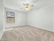Inviting bedroom with neutral carpeting, a ceiling fan, and a window offering natural light at 17210 N Cassi Dr, Surprise, AZ 85374