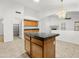 Open concept kitchen features a kitchen island, wood cabinets, stone countertops and recessed lights at 17210 N Cassi Dr, Surprise, AZ 85374