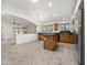 Open kitchen featuring tile flooring, wood cabinets, and an island for food preparation and storage at 17210 N Cassi Dr, Surprise, AZ 85374