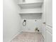 Laundry room with connections, a shelf and neutral tiled floors at 17210 N Cassi Dr, Surprise, AZ 85374