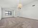 Bright living room with carpet flooring, vaulted ceiling, and a ceiling fan with light fixture at 17210 N Cassi Dr, Surprise, AZ 85374