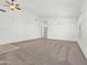 Bright and airy living room with carpet flooring, neutral paint scheme, and seamless archway to other rooms at 17210 N Cassi Dr, Surprise, AZ 85374