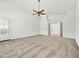 Bright living room with neutral carpeting, fan, and a door to the exterior at 17210 N Cassi Dr, Surprise, AZ 85374