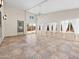 Bright sun room with tile floor, high ceilings, backyard access and large windows with white curtains at 17210 N Cassi Dr, Surprise, AZ 85374