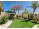 Serene backyard with artificial turf, lush plants, decorative elements, and privacy walls at 18907 N 92Nd Way, Scottsdale, AZ 85255