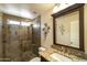 Bathroom featuring a glass-enclosed shower, decorative tile work, and granite countertops at 18907 N 92Nd Way, Scottsdale, AZ 85255