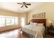 Light and airy main bedroom with hardwood floors, neutral colors, and a view of the backyard at 18907 N 92Nd Way, Scottsdale, AZ 85255