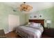 Bedroom featuring a ceiling fan, a bed with decorative bedding, and a closet at 18907 N 92Nd Way, Scottsdale, AZ 85255