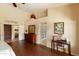 Spacious main bedroom showcasing hardwood floors, vaulted ceilings, and a glimpse into the en-suite bathroom at 18907 N 92Nd Way, Scottsdale, AZ 85255