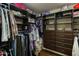 Walk-in closet with custom shelving, drawers, and hanging racks for optimal organization at 18907 N 92Nd Way, Scottsdale, AZ 85255