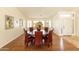 Dining room featuring wood floors, a dark round table, and ample natural light at 18907 N 92Nd Way, Scottsdale, AZ 85255