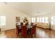 Dining room featuring wood floors, a dark round table, and ample natural light from nearby windows at 18907 N 92Nd Way, Scottsdale, AZ 85255