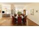 Dining room with hardwood floors, round table, seating for six, and a view of the kitchen at 18907 N 92Nd Way, Scottsdale, AZ 85255