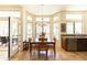 Dining area filled with natural light, featuring tile floors, a wood table, and access to outdoor patio at 18907 N 92Nd Way, Scottsdale, AZ 85255