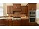 Gourmet kitchen with stainless steel appliances, custom cabinetry, and granite countertops at 18907 N 92Nd Way, Scottsdale, AZ 85255