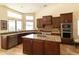 Bright kitchen showcasing granite counters, stainless appliances, and ample counter space beneath large windows at 18907 N 92Nd Way, Scottsdale, AZ 85255