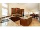 Bright kitchen featuring dark wood cabinetry, granite countertops, and stainless steel appliances at 18907 N 92Nd Way, Scottsdale, AZ 85255