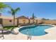 Beautiful backyard pool with a unique shape, rock accents, and a well-maintained patio area at 18907 N 92Nd Way, Scottsdale, AZ 85255