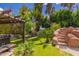 Landscaped backyard with mature plants, spa, and staircase feature at 1907 E Huber St, Mesa, AZ 85203