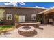 Backyard patio with fire pit and mature landscaping at 1907 E Huber St, Mesa, AZ 85203
