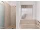 Bathroom featuring a shower and a tub with a window at 1907 E Huber St, Mesa, AZ 85203