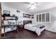 Cozy bedroom with a ceiling fan, neutral paint and carpet, and a collection of baseball hats at 1907 E Huber St, Mesa, AZ 85203