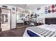 Bedroom with a mirrored closet, collection of baseball memorabilia, and door to another room at 1907 E Huber St, Mesa, AZ 85203