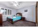 Bedroom featuring a full bed, ceiling fan and light, and window with plantation shutters at 1907 E Huber St, Mesa, AZ 85203
