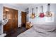Cozy bedroom featuring wood closet doors, hardwood floors and wall-mounted guitars at 1907 E Huber St, Mesa, AZ 85203