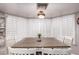 Bright dining area featuring a large window with white shutters and an ornate lighting fixture at 1907 E Huber St, Mesa, AZ 85203