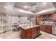 Open kitchen and dining area with granite island, wooden cabinets and bright natural light at 1907 E Huber St, Mesa, AZ 85203