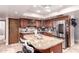 Well-lit kitchen featuring wood cabinetry, granite countertops, and stainless steel appliances at 1907 E Huber St, Mesa, AZ 85203
