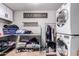 Functional laundry room featuring washer, dryer, folding table and ample storage at 1907 E Huber St, Mesa, AZ 85203